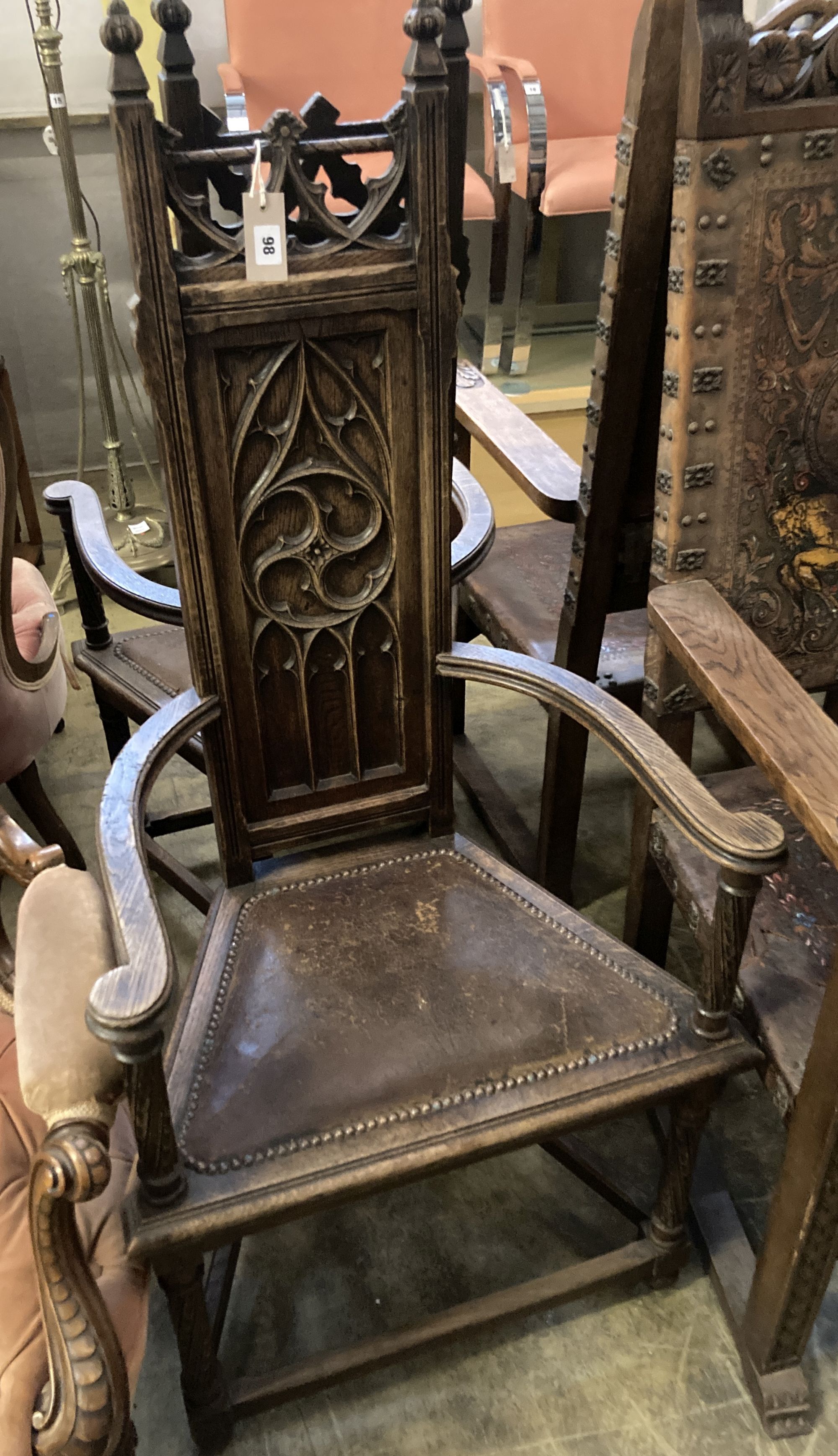 A pair of Gothic-style oak elbow chairs, width 59cm, depth 43cm, height 127cm